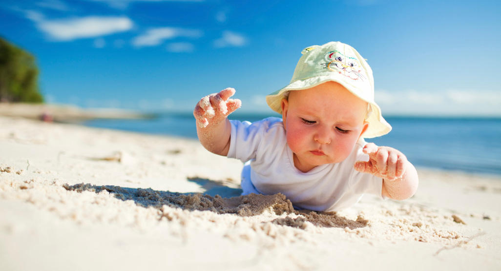 un bebe sur le sable d'une plage